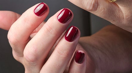 Close-up of expertly manicured red nails at The Glow Way - TGW, Bedford, England, GB.