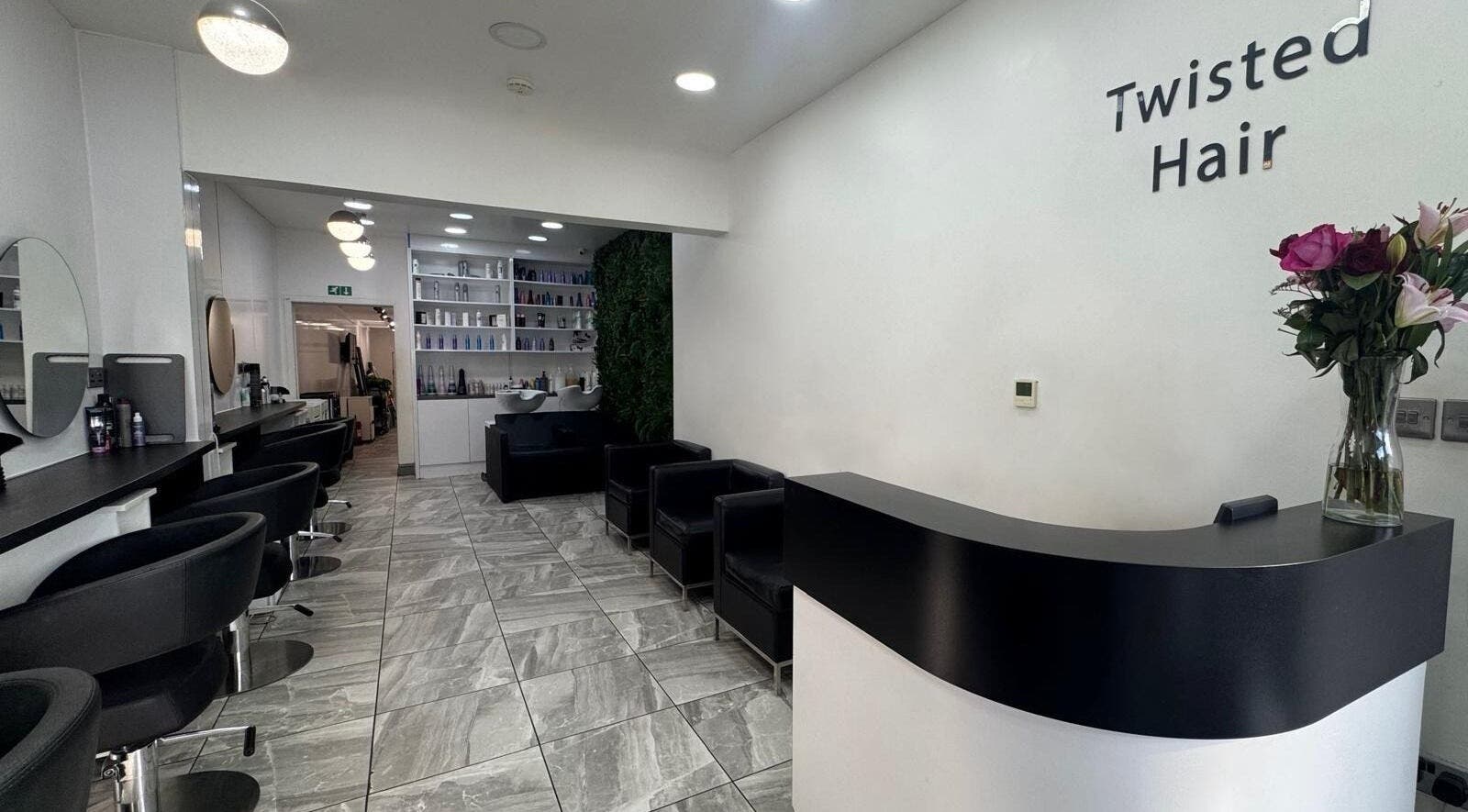 Interior of Twisted Hair salon in Manchester, England, GB, featuring modern decor and seating.