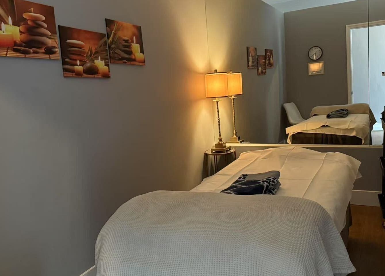 Serene massage room at Unik Spa, Nyack, New York, US, featuring a cozy bed and soothing decor.