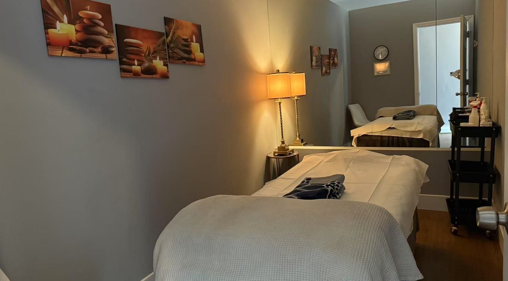 Serene massage room at Unik Spa, Nyack, New York, US, featuring a cozy bed and soothing decor.