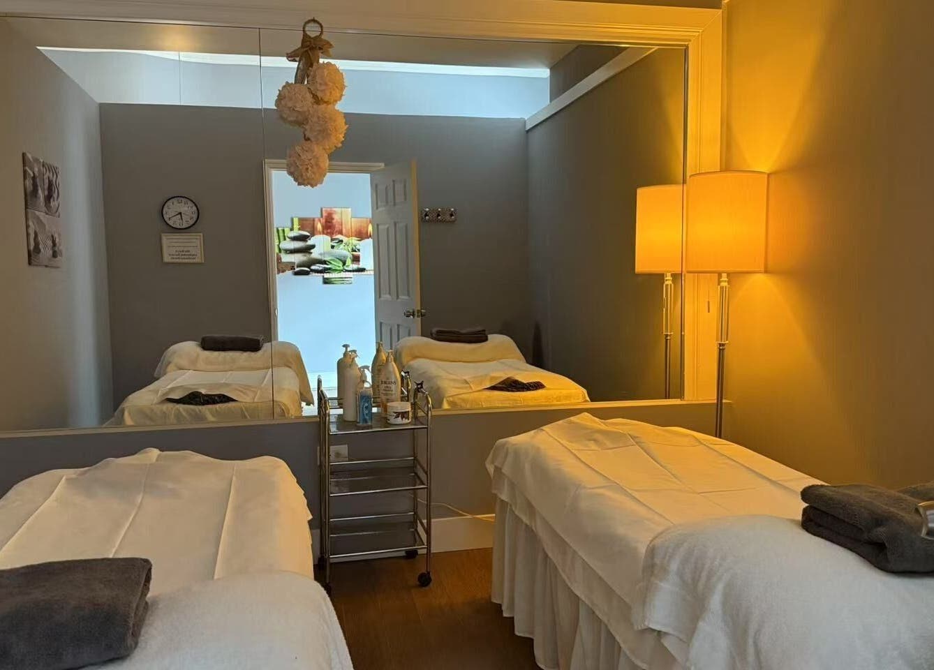 Relaxing massage room at Unik Spa, Nyack, New York, US with tranquil lighting and cozy treatment beds.