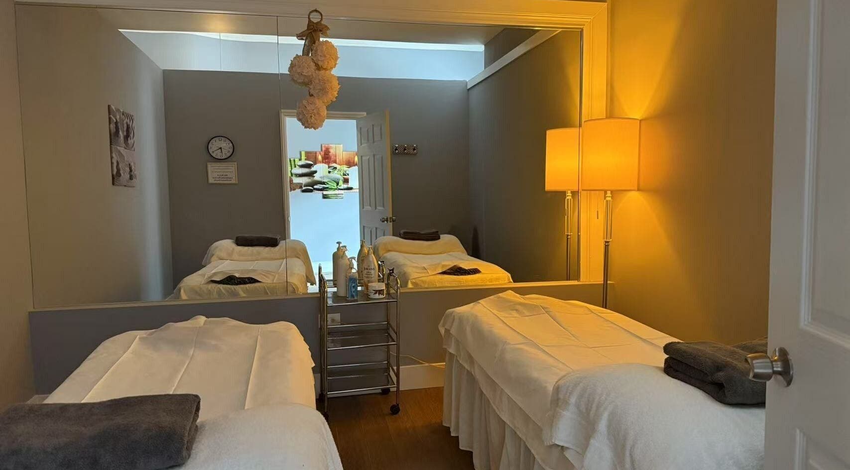 Relaxing massage room at Unik Spa, Nyack, New York, US with tranquil lighting and cozy treatment beds.