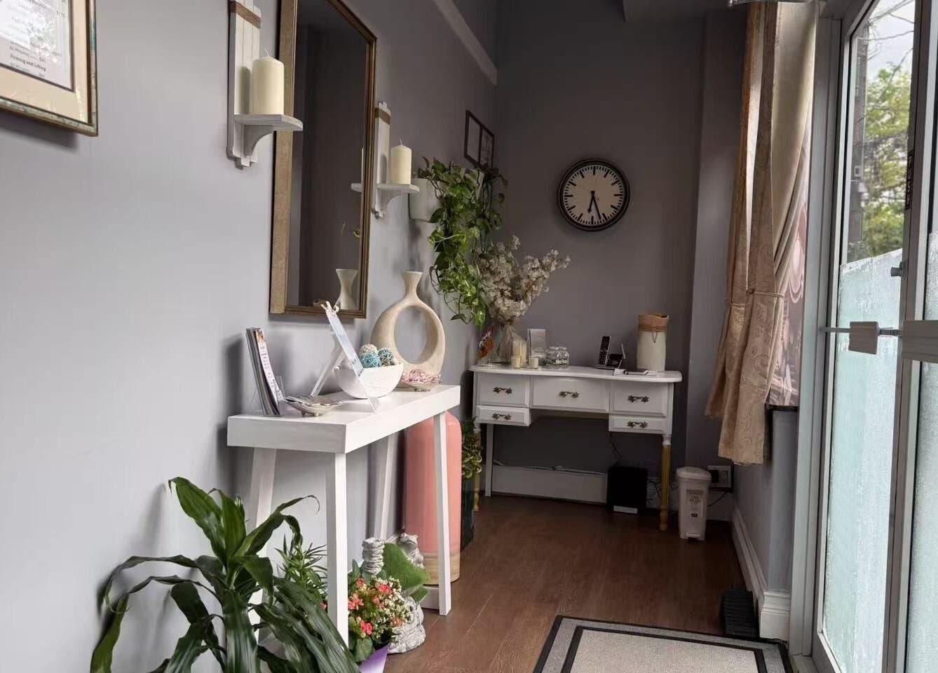 Entrance area of Unik Spa, Nyack, New York, US with elegant decor and greenery.