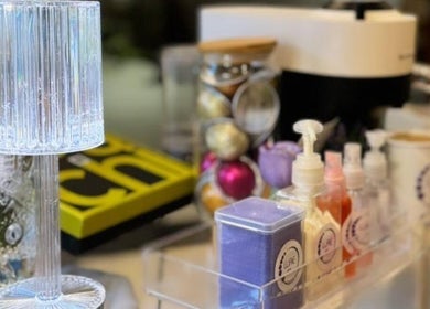 Elegant spa essentials at Lure Home Spa, SA, featuring lotions and glass lamp.