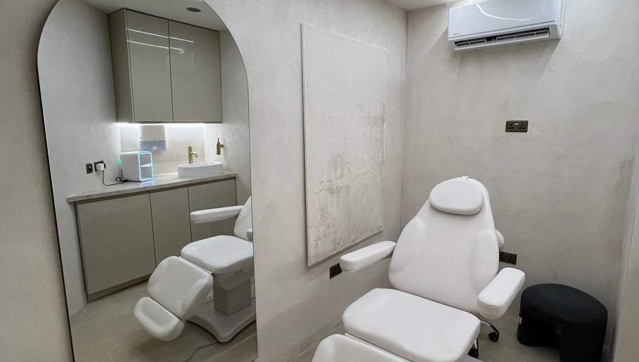 Modern treatment room at Renew By Dr Alisha, London, England, GB with sleek furnishings.