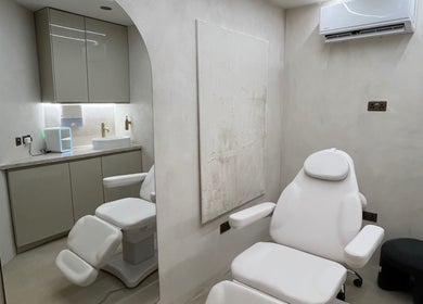 Modern treatment room at Renew By Dr Alisha, London, England, GB with sleek furnishings.