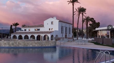 LaMediaLeguaHair's serene poolside at sunset in Comunidad Valenciana, Comunidad Valenciana, ES.