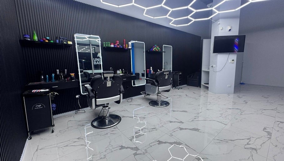 Interior of Unique Barbershop Hamilton New Zealand in Hamilton, Waikato Region, NZ with stylish chairs and lighting.