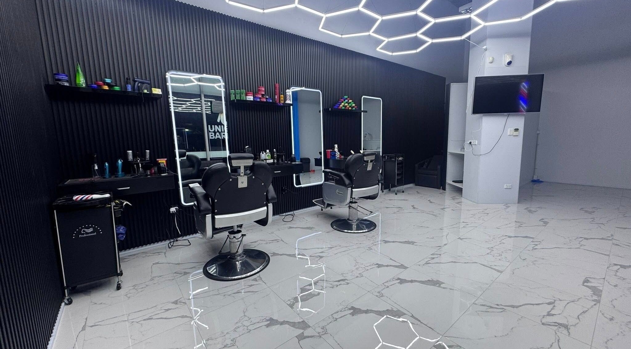 Interior of Unique Barbershop Hamilton New Zealand in Hamilton, Waikato Region, NZ with stylish chairs and lighting.