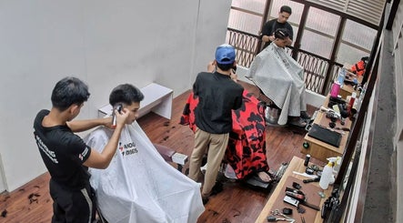 Interior of Manong Barbers Angono, Rizal in Angono, Calabarzon, PH showing barbers at work.