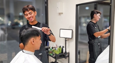 Barber styling hair at Manong Barbers UP Diliman, QC, Quezon City, Metro Manila, PH.