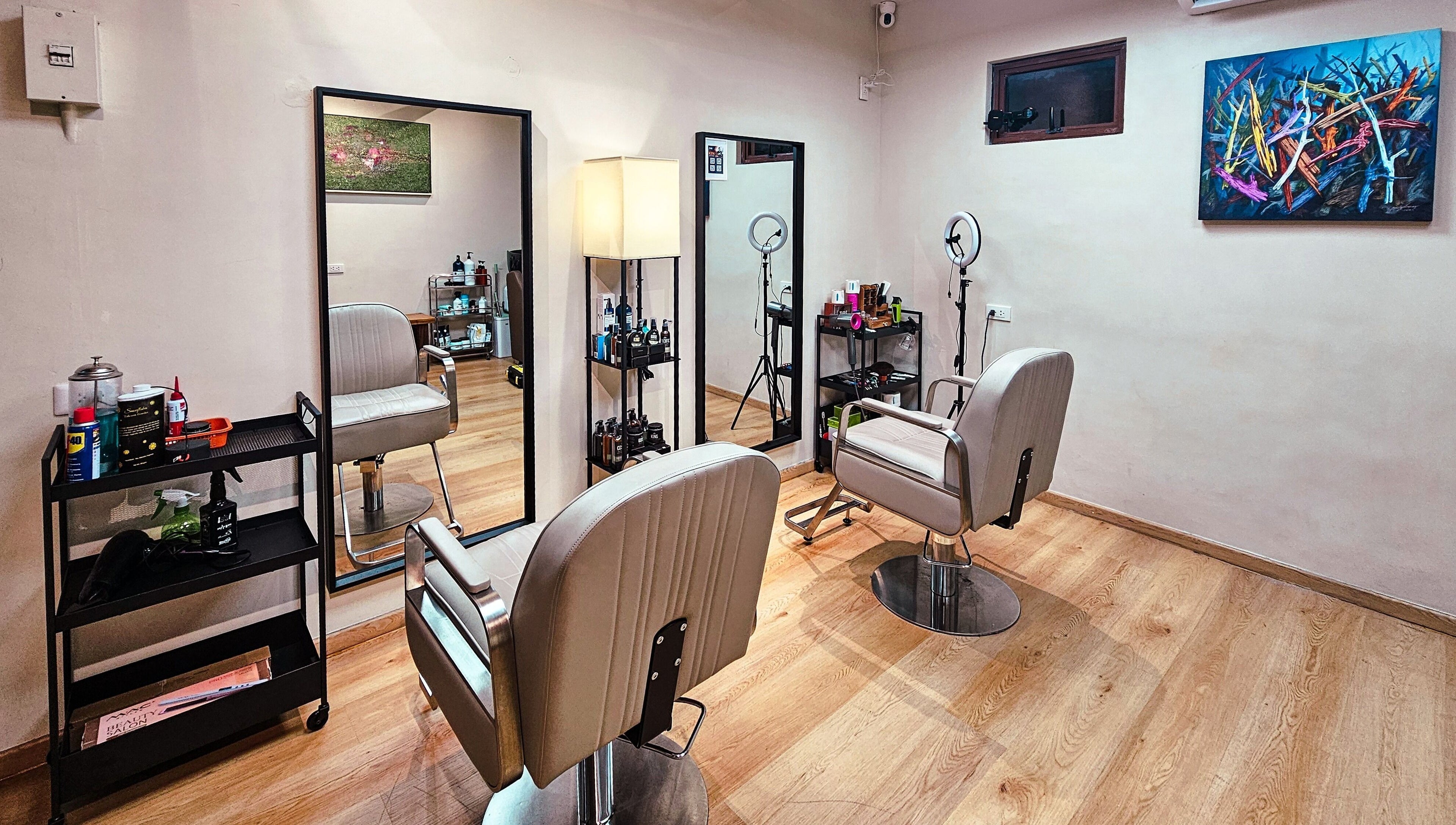 Chic interior of Manong Barbers Studio - UP Diliman, QC in Quezon City, Metro Manila, PH. Modern chairs and mirrors.