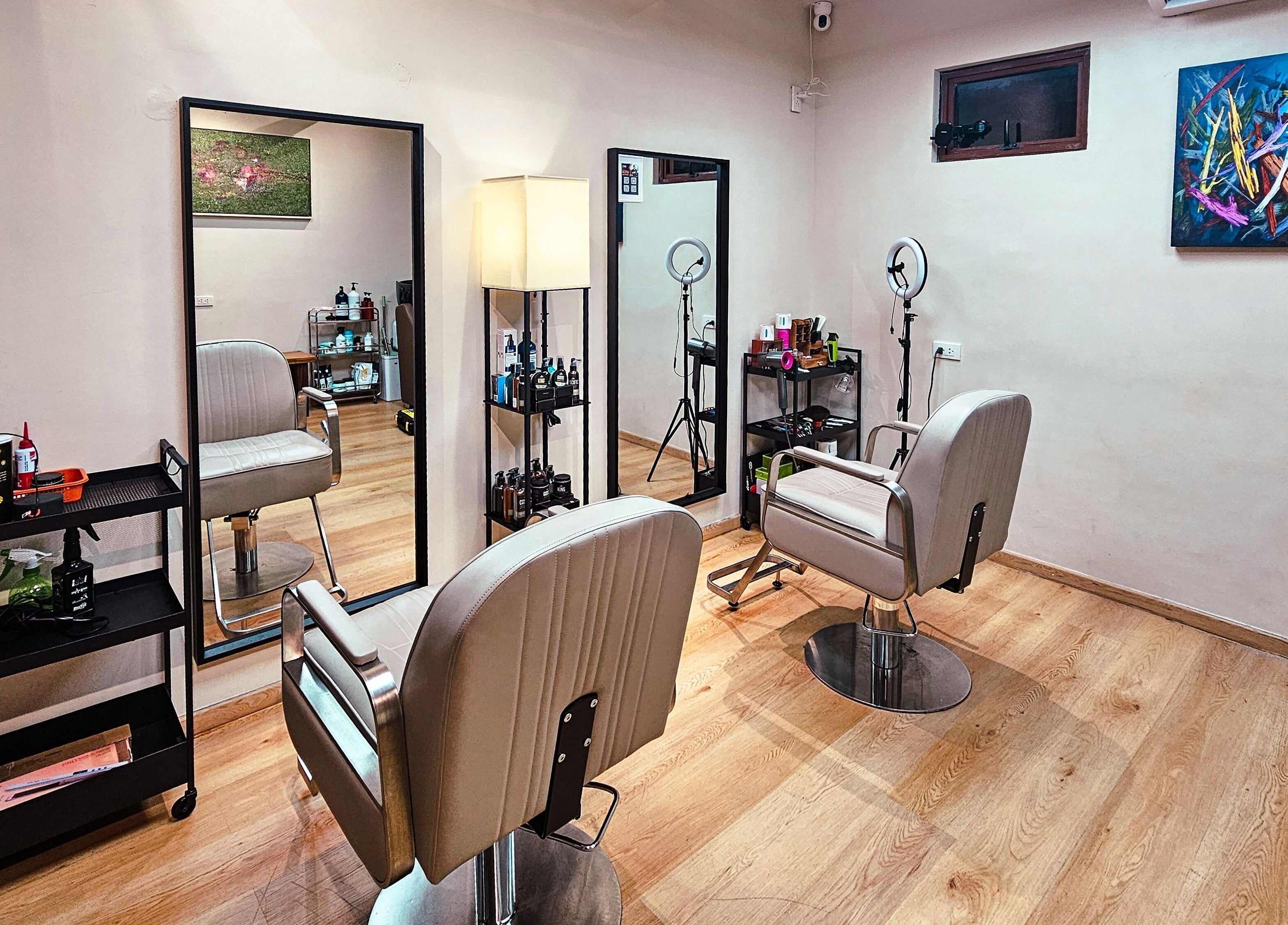 Chic interior of Manong Barbers Studio - UP Diliman, QC in Quezon City, Metro Manila, PH. Modern chairs and mirrors.