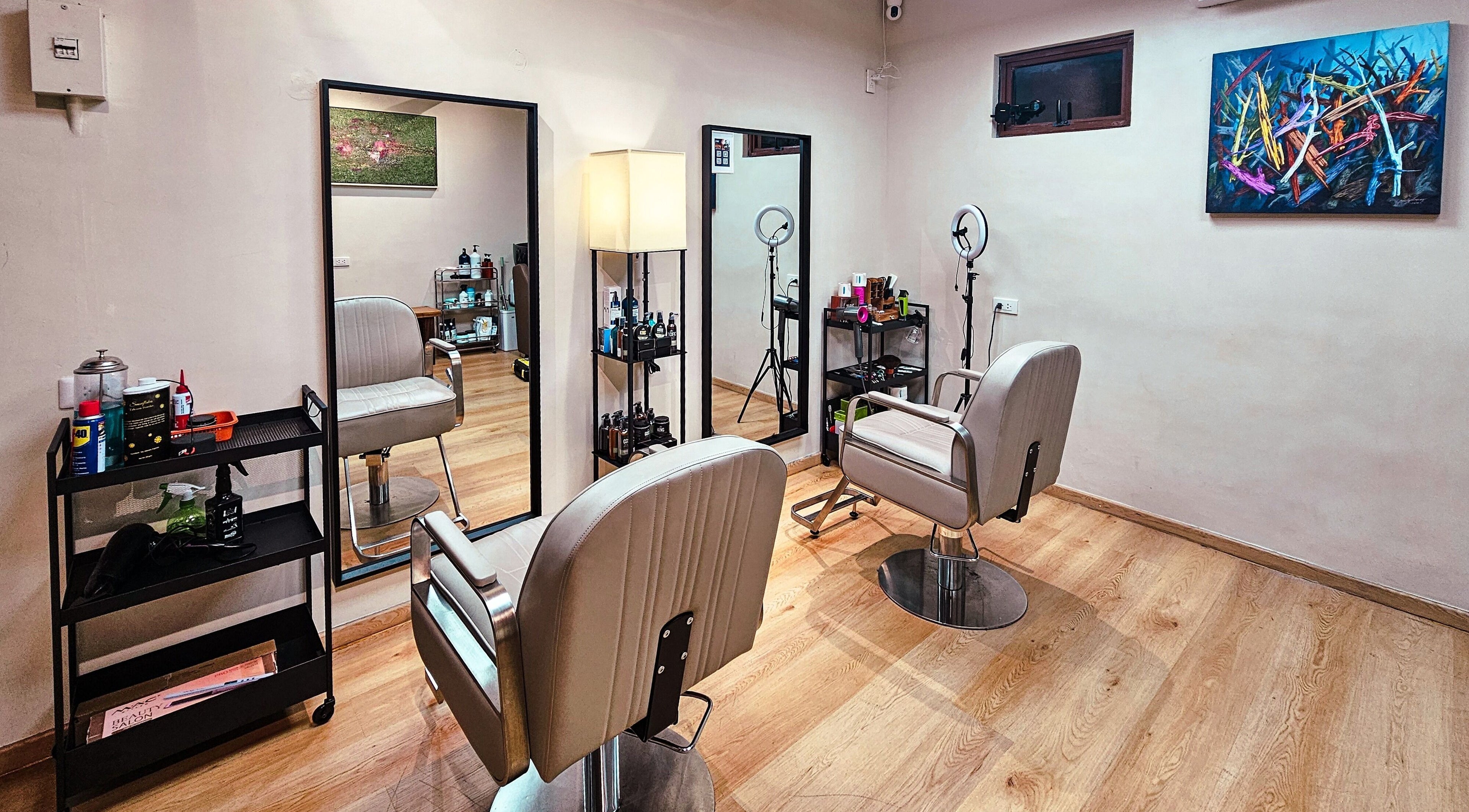 Chic interior of Manong Barbers Studio - UP Diliman, QC in Quezon City, Metro Manila, PH. Modern chairs and mirrors.