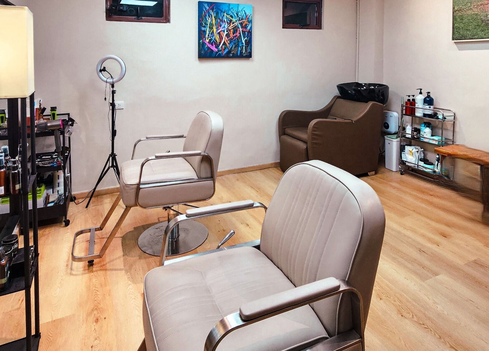 Stylish interior at Manong Barbers Studio - UP Diliman, QC in Quezon City, Metro Manila, PH with modern chairs.