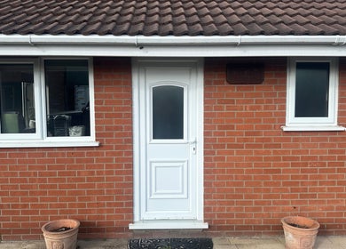 Front view of The Tanning Hut, Doncaster, England. Red brick exterior with white door and windows.