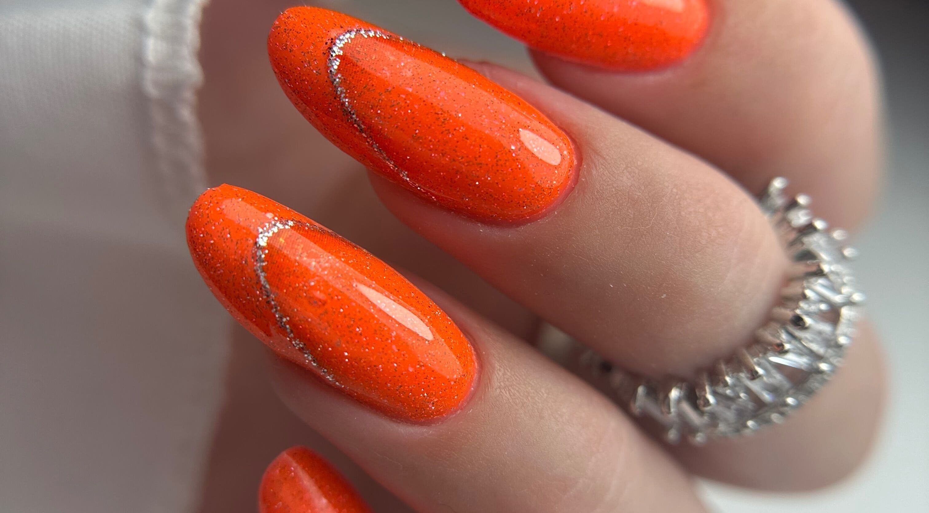 Stylish orange glitter nails at Daniela Siantova Nail Courses in Hull, England, GB, showcasing expert artistry.