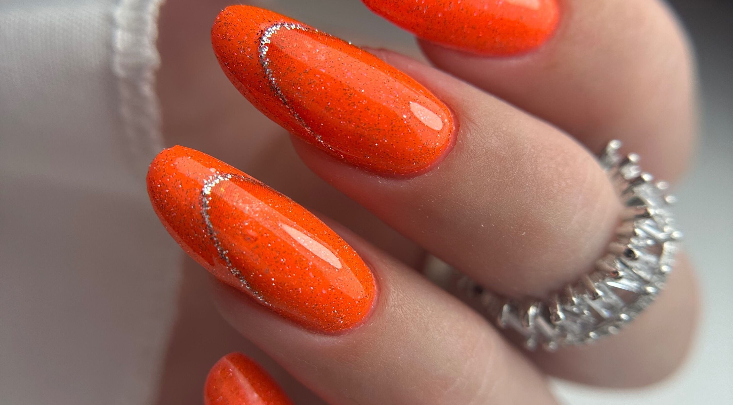 Stylish orange glitter nails at Daniela Siantova Nail Courses in Hull, England, GB, showcasing expert artistry.