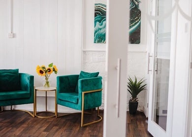 Elegant seating area at Kate Brooks ~ Nail Artist in Llandudno, Wales, GB, featuring plush green chairs.
