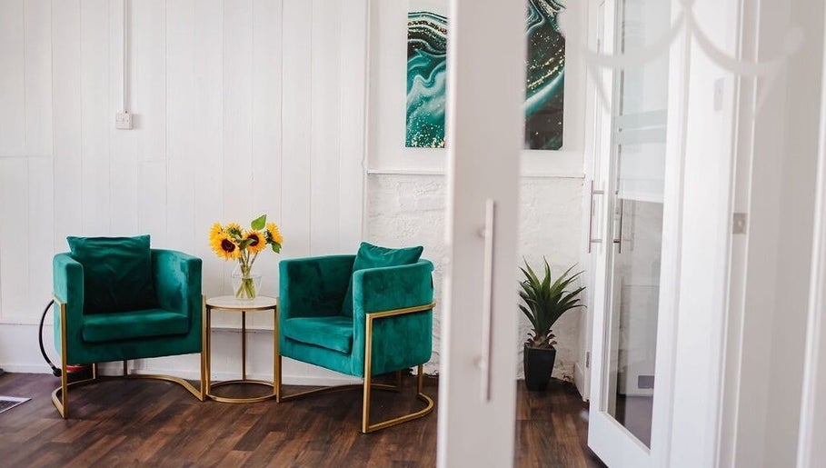 Bright waiting area at Kate Brooks ~ Nail Artist in Llandudno, Wales, GB with green chairs and sunflowers.
