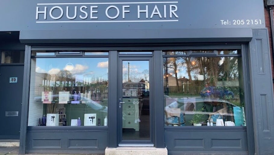 Front view of Mbhairdressing at Forest Hall, Newcastle Upon Tyne, England, GB showcasing modern glass facade.