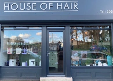 Front view of Mbhairdressing at Forest Hall, Newcastle Upon Tyne, England, GB showcasing modern glass facade.