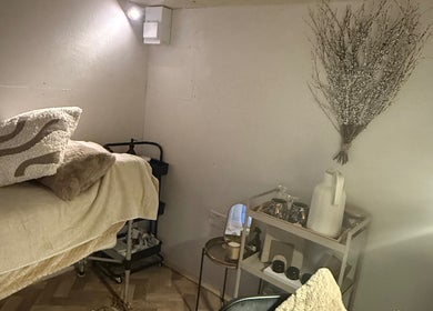 Relaxing treatment room at Beautyby L Cheshire in Northwich, England, GB with cozy bedding and decor.