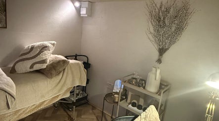 Relaxing treatment room at Beautyby L Cheshire in Northwich, England, GB with cozy bedding and decor.