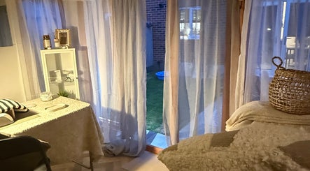 Relaxing treatment room at Beautyby L Cheshire, Northwich, England, GB with soft curtains and cozy decor.
