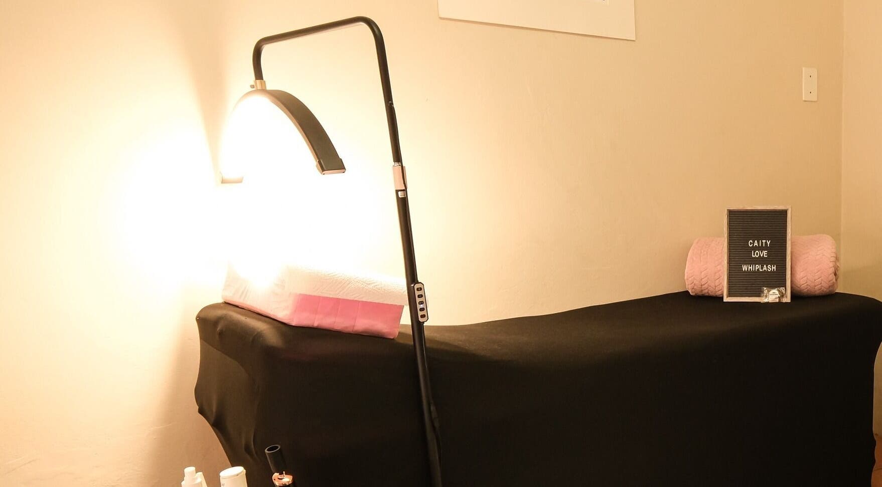 Comfortable massage bed at Whiplash, East London, Eastern Cape, ZA, lit warmly for a relaxing ambiance.