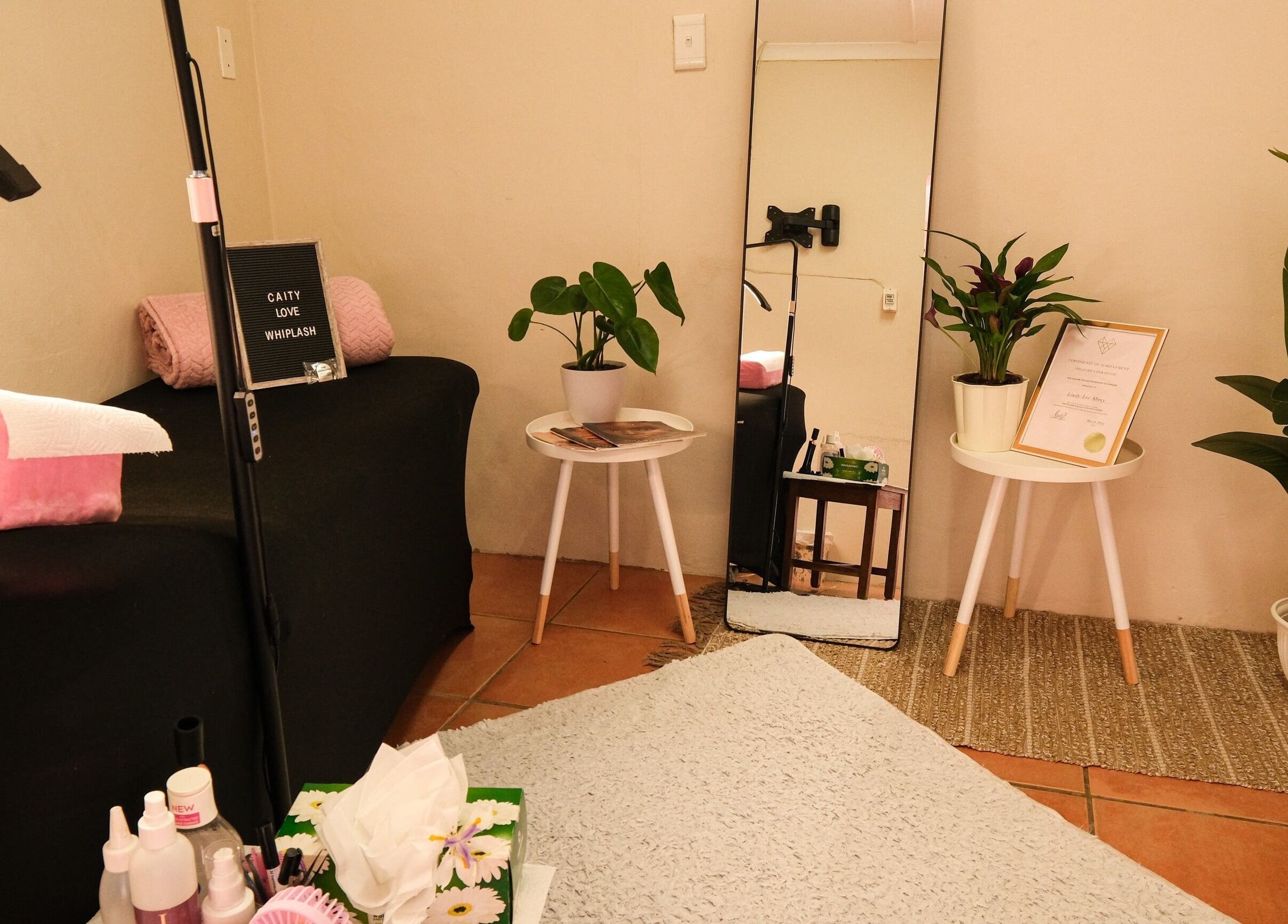 Relaxing beauty corner at Whiplash, East London, Eastern Cape, ZA, with plants and wellness certificates.