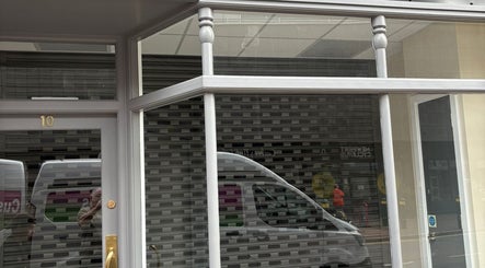 Entrance of Thaidy Massage, Newport, Wales, GB showcasing elegant glass windows and door.