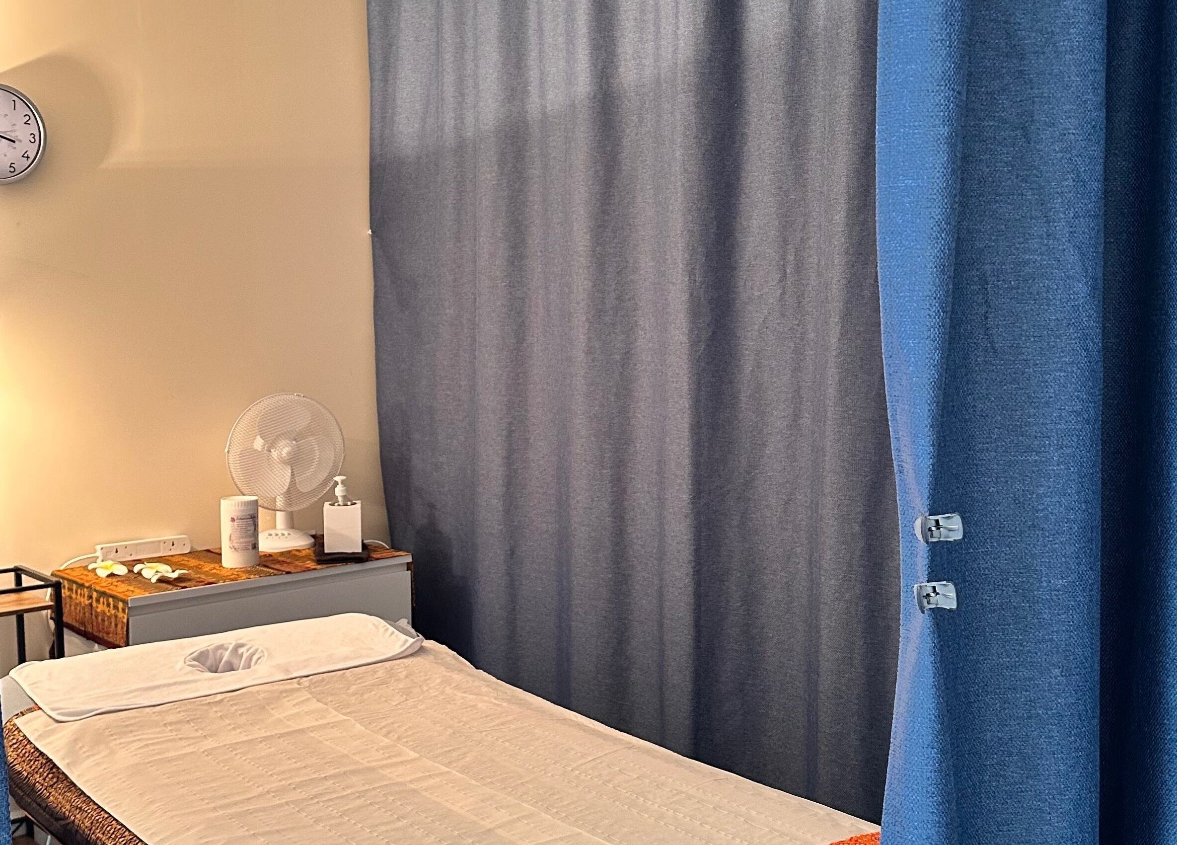 Relaxing massage room at Thaidy Massage, Newport, Wales, GB, featuring a massage bed and calming curtains.