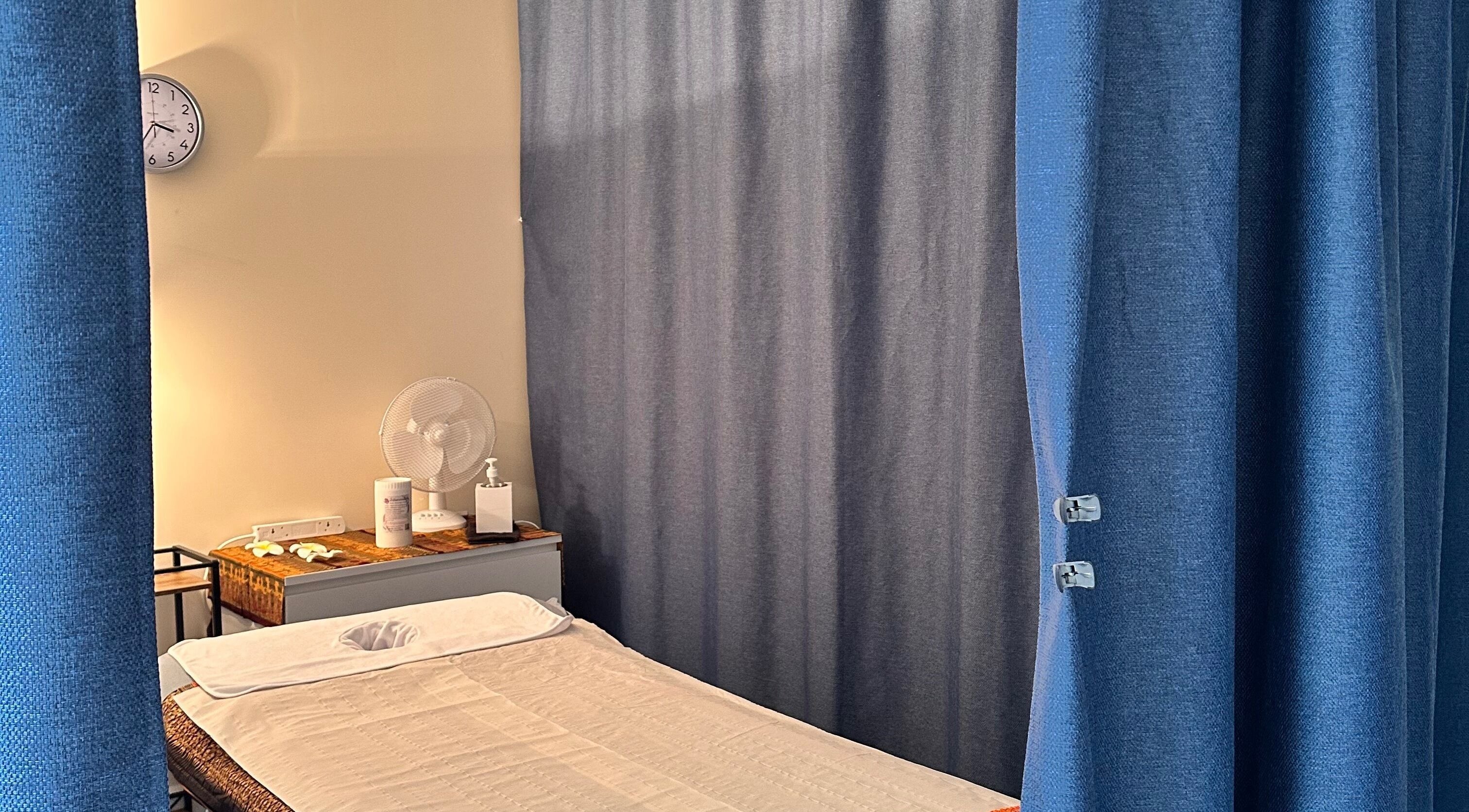 Relaxing massage room at Thaidy Massage, Newport, Wales, GB, featuring a massage bed and calming curtains.