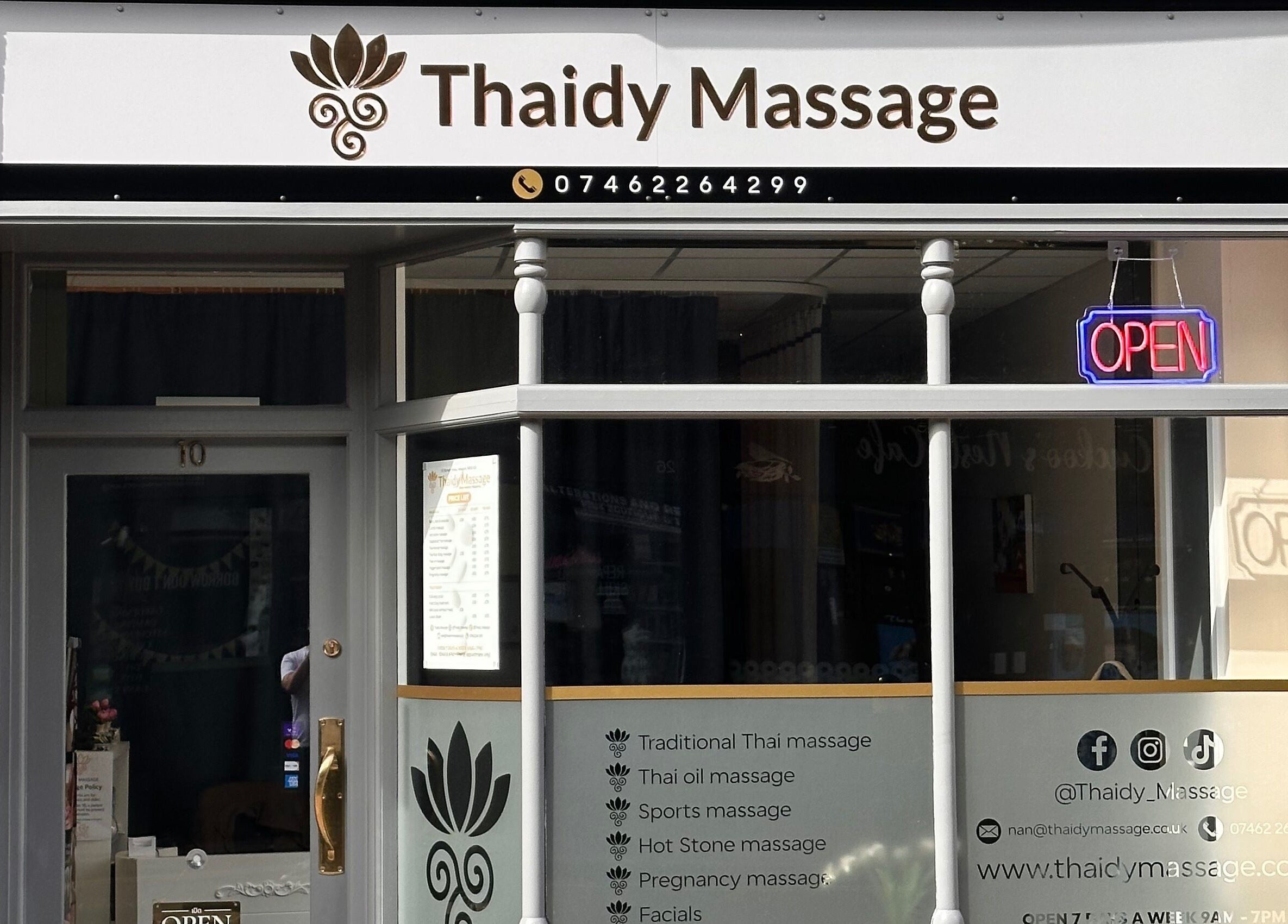 Thaidy Massage entrance in Newport, Wales, GB with a bright open sign and service listings.
