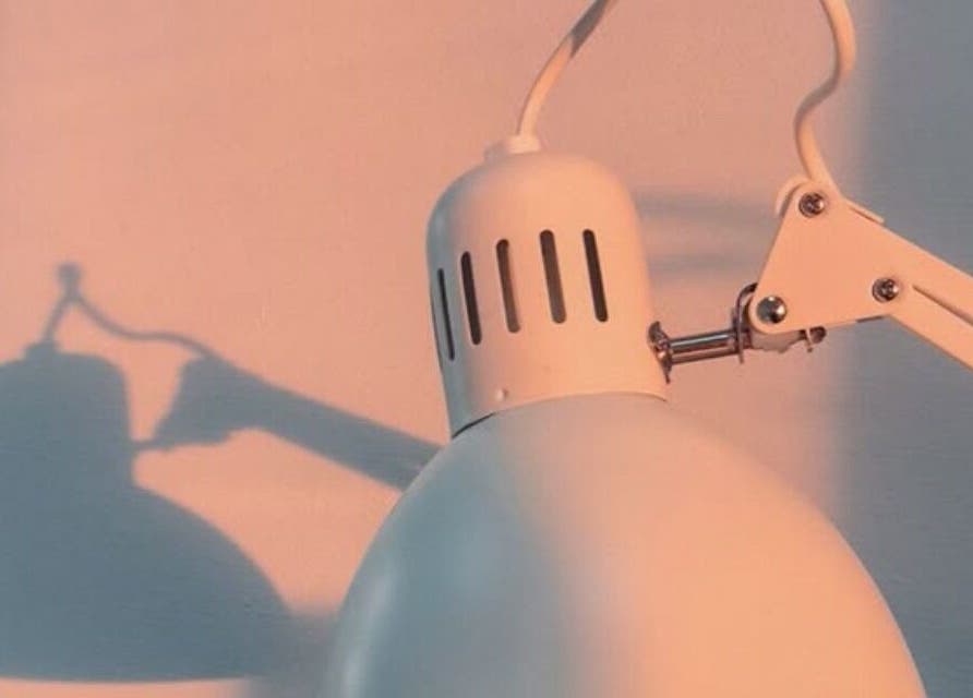 Modern lamp casting artistic shadows at Classic Touch, Noord, AW enhancing serene beauty ambiance.