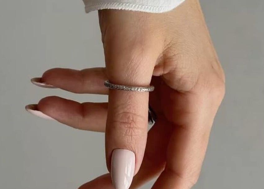 Manicured hand showcases elegance with a ring at Classic Touch, Noord, AW. Perfect for beauty and wellness.