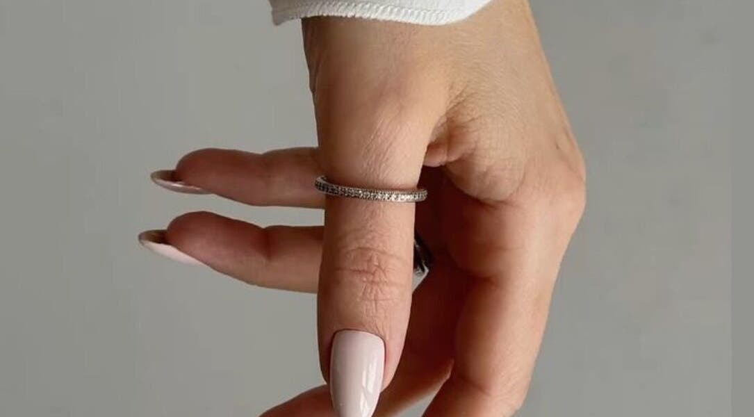 Manicured hand showcases elegance with a ring at Classic Touch, Noord, AW. Perfect for beauty and wellness.