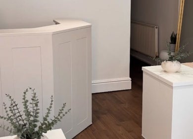 Elegant reception area at Halo Skin Lab in Worsley, England, GB with modern decor and plant accents.