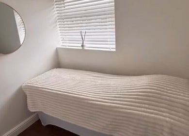 Relaxing treatment bed at Halo Skin Lab, Worsley, England, GB, offering a tranquil spa experience.