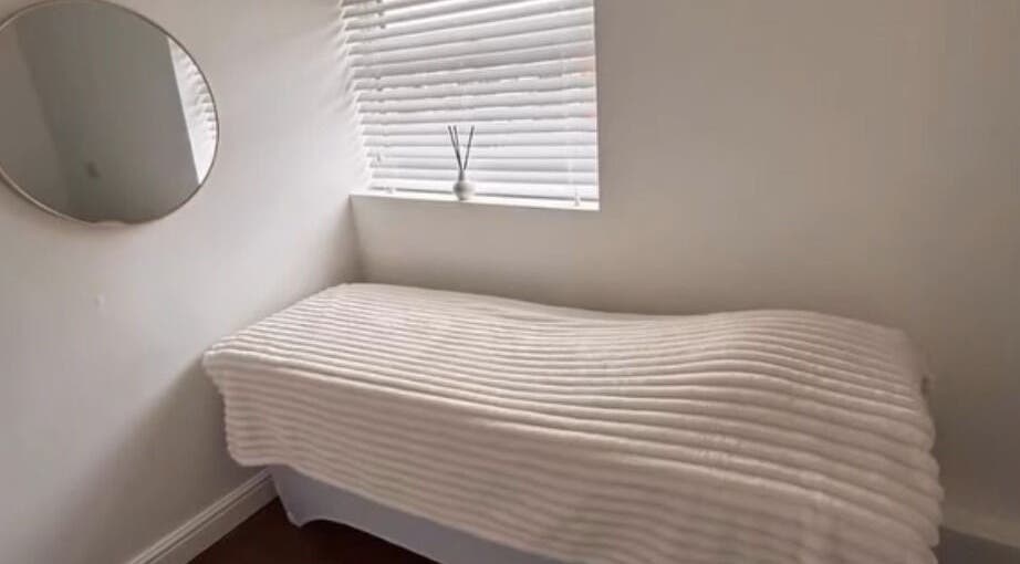 Elegant treatment room at Halo Skin Lab in Worsley, England, GB with a plush bed and calming decor.