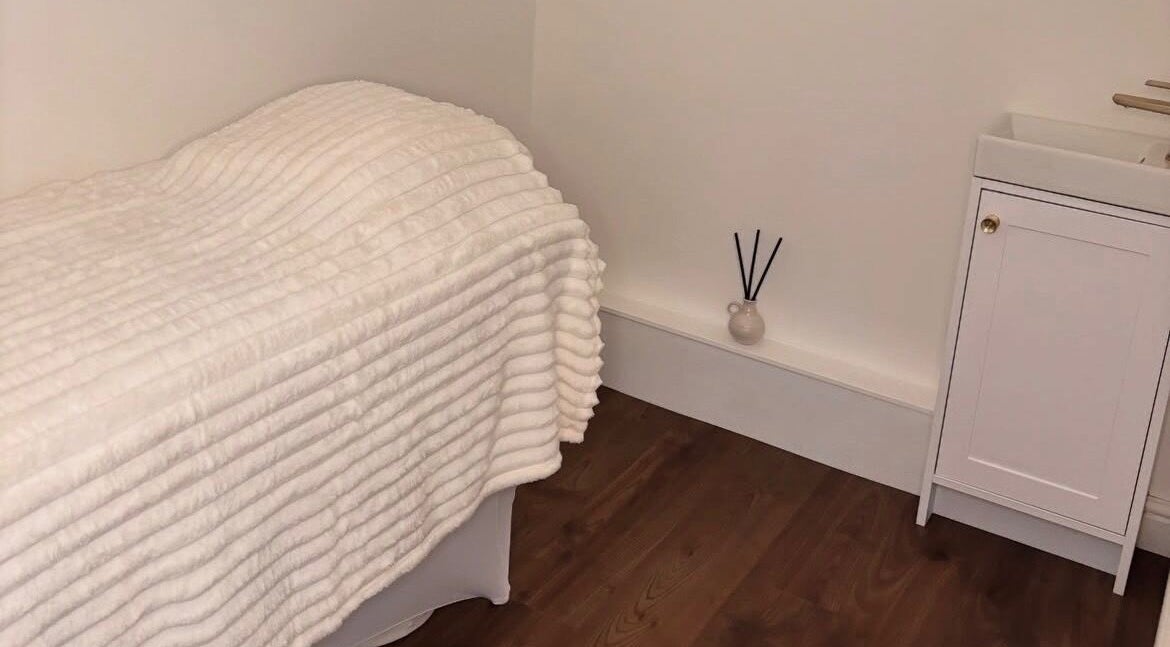 Tranquil treatment room at Halo Skin Lab, Worsley, England, GB. Cozy bed, elegant decor promise relaxation.