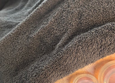 Relaxing cupping therapy at JSB Practices, Ilford, England, GB with soft towel cover.