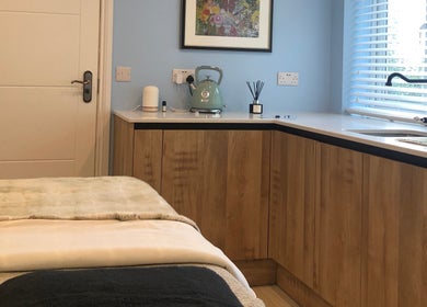 Relaxing treatment room at Beauty by Appointment, Colgate, England, GB, featuring a cozy massage table.