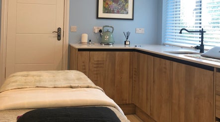 Relaxing treatment room at Beauty by Appointment, Colgate, England, GB, featuring a cozy massage table.