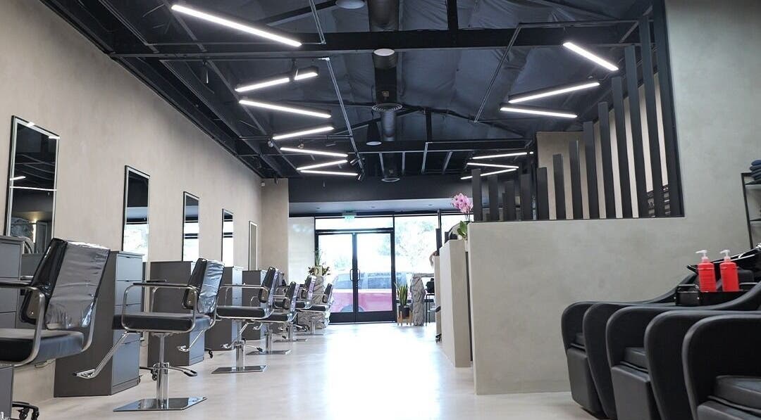 Modern interior of Marko Beauty Salon in Glendale, California, US with stylish black chairs and sleek design.