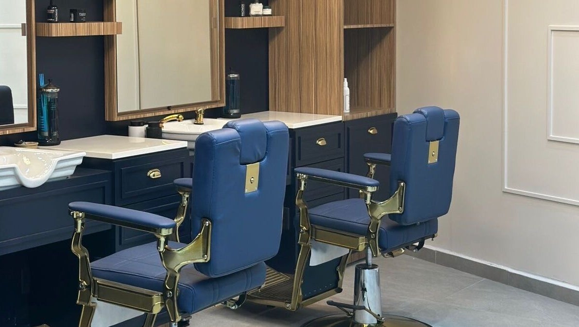 Moderna barbería en Scotch & Blade, Cuajimalpa, Ciudad de México, MX con sillas de cuero azul elegante.