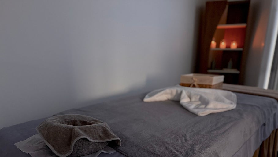 Massage table setup at Rivera Spa and Massage, Christchurch, Canterbury Region, NZ with candles in background.