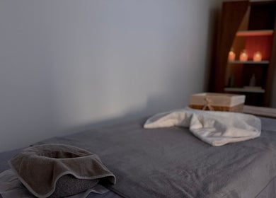 Massage table setup at Rivera Spa and Massage, Christchurch, Canterbury Region, NZ with candles in background.