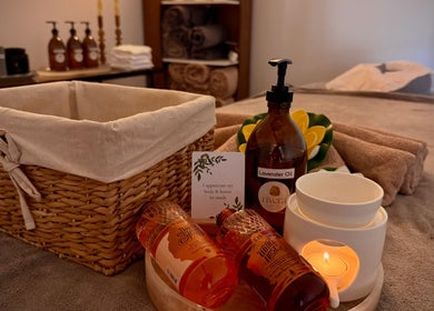 Tranquil massage setup at Rivera Spa and Massage, Christchurch, Canterbury Region, NZ with lavender oils and candles.